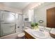 Bright bathroom features a vanity, toilet, tub, shower, and mirrored medicine cabinet at 1529 Ashcroft Dr, Longmont, CO 80501