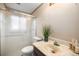 Tight bathroom with walk-in shower, low-flow toilet, and a vanity with marbled top at 1529 Ashcroft Dr, Longmont, CO 80501