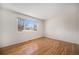Spacious bedroom with hardwood floors, natural light, and neutral tones creating a relaxing atmosphere at 1529 Ashcroft Dr, Longmont, CO 80501