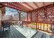 Shaded rear deck with lattice work, outdoor furniture, and a view of the fenced yard at 1529 Ashcroft Dr, Longmont, CO 80501