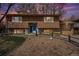 Charming two-story home at sunset with a blue front door, landscaped front yard, and a two car garage at 1529 Ashcroft Dr, Longmont, CO 80501
