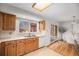Functional kitchen featuring wooden cabinets, ample counter space, and a view to the outdoor deck at 1529 Ashcroft Dr, Longmont, CO 80501