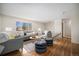 Inviting living room with a large window, hardwood floors, and stylish decor creating a cozy atmosphere at 1529 Ashcroft Dr, Longmont, CO 80501