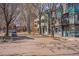 Quiet street with modern apartments on a sunny day, with mature trees lining the road at 1529 Ashcroft Dr, Longmont, CO 80501