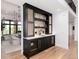 Stylish black bar area with marble countertop, built-in wine coolers, and decorative backsplash at 860 Diamond Ridge Cir, Castle Rock, CO 80108
