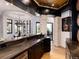 An entertainer's bar area featuring a dark countertop with black cabinetry and stone-look support columns at 860 Diamond Ridge Cir, Castle Rock, CO 80108