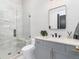 Modern bathroom featuring glass shower with bench and gray vanity with black fixtures and rectangular mirror at 860 Diamond Ridge Cir, Castle Rock, CO 80108