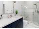 Bright bathroom with modern vanity, stone countertop and walk-in shower at 860 Diamond Ridge Cir, Castle Rock, CO 80108