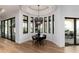Open dining area boasts contemporary lighting, large windows, and seamless access to outdoor patio at 860 Diamond Ridge Cir, Castle Rock, CO 80108