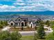 Breathtaking exterior view of a stunning estate with mountain views and lush landscaping at 860 Diamond Ridge Cir, Castle Rock, CO 80108