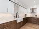 Modern kitchen features two-tone cabinetry with sleek hardware, quartz countertops, stainless steel appliances, and farmhouse sink at 860 Diamond Ridge Cir, Castle Rock, CO 80108