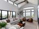 Bright living room with vaulted ceilings, a cozy seating area, and expansive windows offering panoramic views at 860 Diamond Ridge Cir, Castle Rock, CO 80108