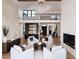 Spacious living room with soaring ceilings, stone accents, and stylish furnishings, perfect for entertaining at 860 Diamond Ridge Cir, Castle Rock, CO 80108