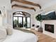 Light-filled main bedroom features vaulted ceilings, exposed wood beams, fireplace, and large windows offering scenic views at 860 Diamond Ridge Cir, Castle Rock, CO 80108