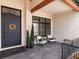 Inviting front porch featuring stylish seating, elegant decor, and a beautifully textured stone wall at 860 Diamond Ridge Cir, Castle Rock, CO 80108