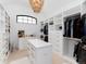 Well-organized walk-in closet with custom shelving, ample storage space, and a stylish chandelier at 860 Diamond Ridge Cir, Castle Rock, CO 80108