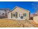 View of the backyard featuring siding and stone detail, plus a grill on the small patio at 22134 Wintergreen Way, Parker, CO 80138