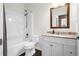 Bathroom with a tub-shower combo, toilet, and vanity with a mirror and granite countertop at 22134 Wintergreen Way, Parker, CO 80138