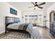 Bright bedroom with a large window, ceiling fan, neutral colors, and modern furnishings at 22134 Wintergreen Way, Parker, CO 80138