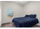 Cozy bedroom with a bed, window, and neutral-colored walls and carpet at 22134 Wintergreen Way, Parker, CO 80138