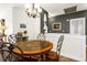 Cozy dining room featuring a unique light fixture, wall decor, and a distinctive oval table and chairs set at 22134 Wintergreen Way, Parker, CO 80138