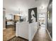 Hallway view showcasing the home's open layout, connecting kitchen, living space, and bedroom at 22134 Wintergreen Way, Parker, CO 80138