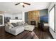 Cozy living room with stone fireplace, gray sectional, adjacent to kitchen, ideal for relaxation and gatherings at 22134 Wintergreen Way, Parker, CO 80138