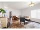 Bright and airy living room boasts tile flooring, comfortable seating arrangements, and a large window at 22134 Wintergreen Way, Parker, CO 80138