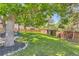 Lush green backyard featuring a swing, climbing area, and plenty of space for outdoor activities at 9492 Crestmore Way, Highlands Ranch, CO 80126