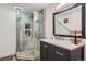 Modern bathroom features a glass enclosed shower, stone floor, updated fixtures, and vanity at 9492 Crestmore Way, Highlands Ranch, CO 80126