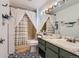 Bathroom featuring patterned floor tiles, a shower/tub, and plenty of vanity storage at 9492 Crestmore Way, Highlands Ranch, CO 80126