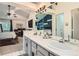 En-suite bathroom boasts a marble countertop, bright vanity lighting, and contemporary fixtures at 9492 Crestmore Way, Highlands Ranch, CO 80126