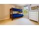 Bedroom with blue bunk beds, natural light from the window, and a white dresser with silver knobs at 9492 Crestmore Way, Highlands Ranch, CO 80126
