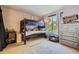 Bedroom featuring a bunk bed, large window, and cozy sitting area to create the perfect getaway at 9492 Crestmore Way, Highlands Ranch, CO 80126
