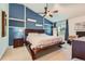 Stylish bedroom with a vaulted ceiling, a dark wood bed frame, and custom shelving at 9492 Crestmore Way, Highlands Ranch, CO 80126