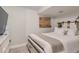 Cozy bedroom featuring white walls and decor with a sliding panel headboard at 9492 Crestmore Way, Highlands Ranch, CO 80126
