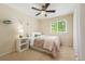 Bright bedroom featuring neutral carpet, a ceiling fan, and a sunny window with natural light shining in at 9492 Crestmore Way, Highlands Ranch, CO 80126