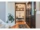 Cozy entryway with rustic wood accents, storage shelves, and a welcoming bench at 9492 Crestmore Way, Highlands Ranch, CO 80126