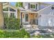 Charming home featuring a brick entryway, flower pots and a cozy porch seating area at 9492 Crestmore Way, Highlands Ranch, CO 80126