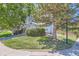 Well-maintained front yard with green grass, mature trees, and blue house at 9492 Crestmore Way, Highlands Ranch, CO 80126