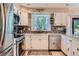Bright kitchen featuring stainless appliances, a bay window, and sleek countertops at 9492 Crestmore Way, Highlands Ranch, CO 80126