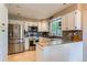Modern kitchen with stainless steel appliances, white cabinets, and stylish backsplash at 9492 Crestmore Way, Highlands Ranch, CO 80126