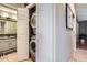 Efficient laundry area featuring a stacked washer and dryer with a tiled bathroom just across the hall at 9492 Crestmore Way, Highlands Ranch, CO 80126