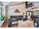Spacious living room with high ceilings, a cozy gray sectional, and an open view to the dining area at 9492 Crestmore Way, Highlands Ranch, CO 80126