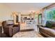 Open-concept living room flows into a bright kitchen with stainless steel appliances and a dining area with backyard access at 9492 Crestmore Way, Highlands Ranch, CO 80126