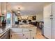 Open-concept living space with a kitchen island, fireplace, and comfortable seating area at 9492 Crestmore Way, Highlands Ranch, CO 80126