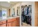 Bathroom with a walk-in closet and granite vanity at 10518 Christopher Dr, Conifer, CO 80433