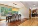 Bright dining room with hardwood floors and large windows offering scenic views at 10518 Christopher Dr, Conifer, CO 80433