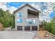 Exterior view of home with three-car garage and decks at 10518 Christopher Dr, Conifer, CO 80433