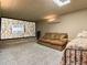 Basement home theater with large screen, sofa, and sleeping area at 10518 Christopher Dr, Conifer, CO 80433